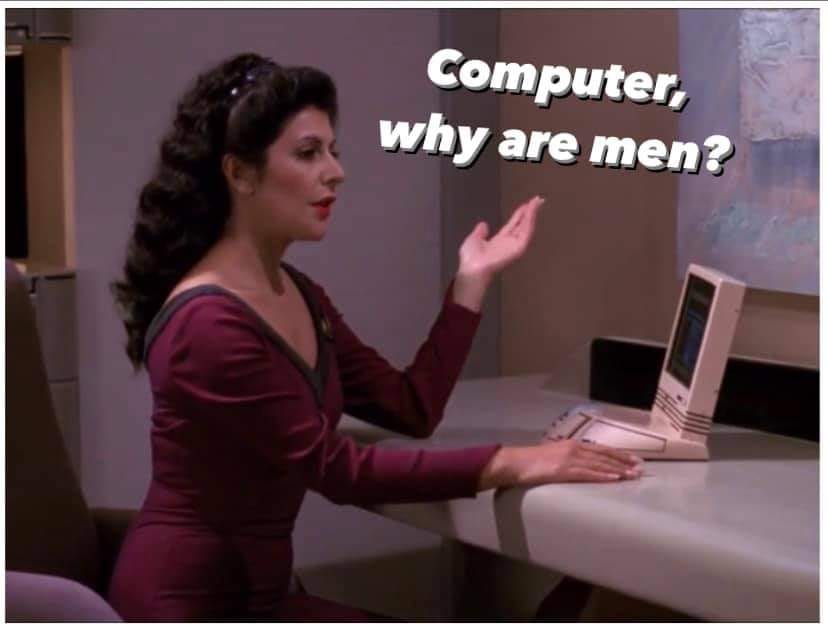 The meme is a humorous image featuring a character from the TV show Star Trek: The Next Generation, Deanna Troi, sitting at a computer. The image is captioned "Computer, why are men?" implying that Deanna is asking the computer to explain the nature of men, but the response is not provided, leaving the question unanswered. The meme is likely intended to be humorous and ironic, poking fun at the idea that men are somehow mysterious or inexplicable.